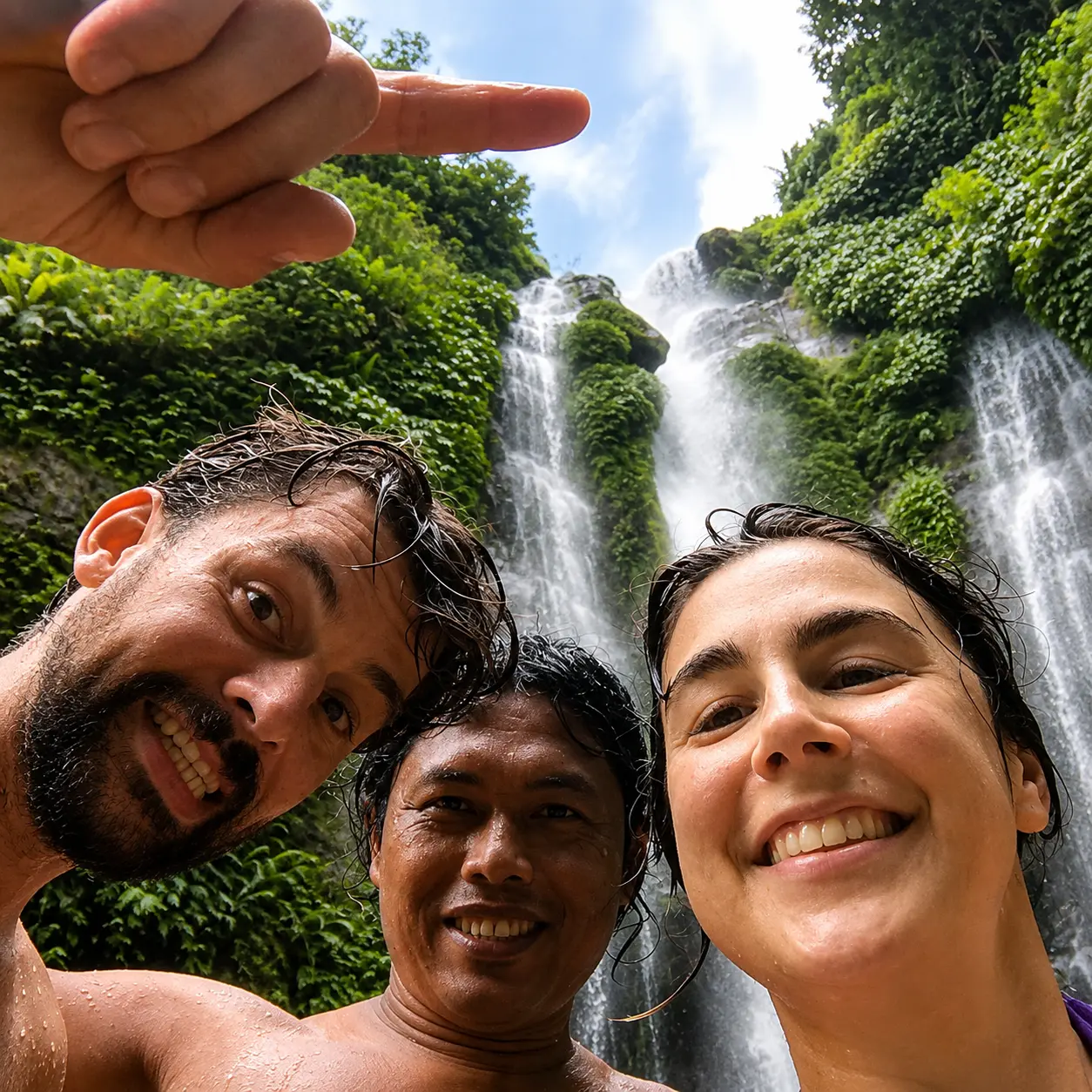 Our local guide and happy travelers at a North Bali waterfall